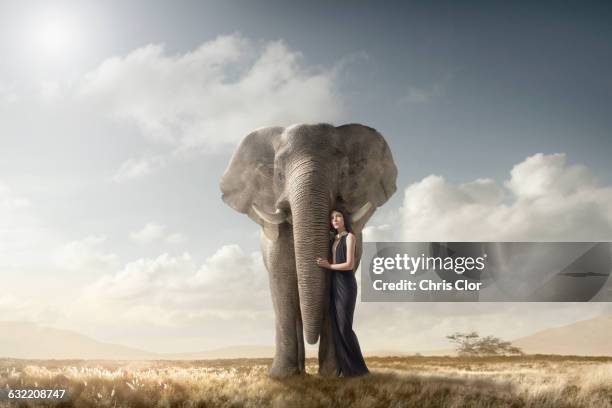 woman hugging elephant in remote field - 30代の女性一人点のイラスト素材／クリップアート素材／マンガ素材／アイコン素材