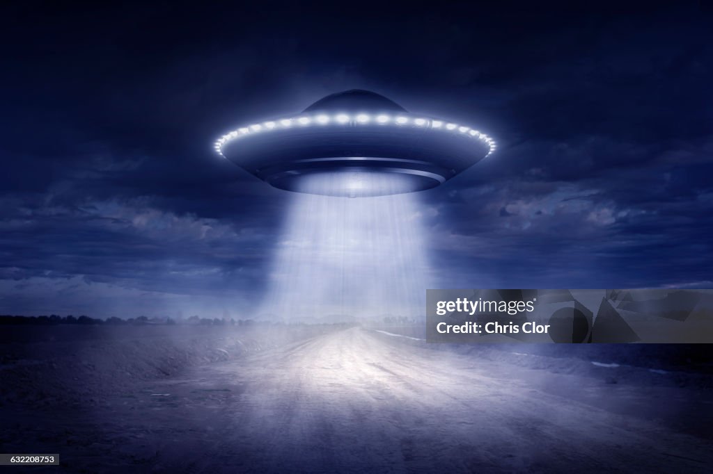 Alien spaceship landing on rural road