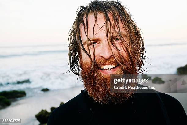 caucasian surfer with wet hair at beach - men long wet hair foto e immagini stock