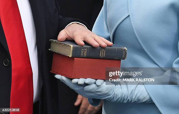 President-elect Donald Trump's wife holds a Bible as Trump is sworn in as President on January 20, 2017 at the US Capitol in Washington, DC. / AFP /...