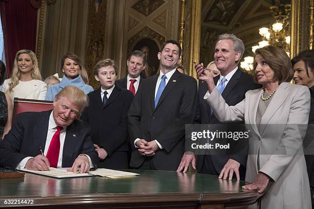 President Donald Trump is joined by the Congressional leadership and his family as he formally signs his cabinet nominations into law, in the...