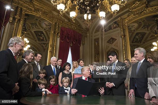 President Donald Trump is joined by the Congressional leadership and his family as he formally signs his cabinet nominations into law, in the...