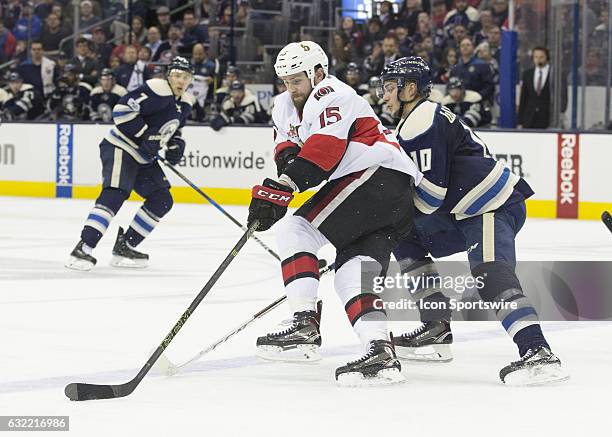 Zack Smith of the Ottawa Senators and Alexander Wennberg of the Columbus Blue Jackets battle for the puck during the third period of the gamebetween...