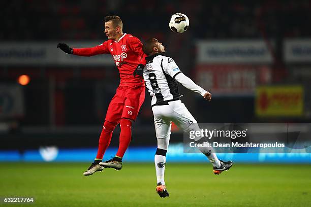 Bersant Celina of FC Twente challenges for the headed ball with Lerin Duarte of Heracles Almelo during the Dutch Eredivisie match between FC Twente...
