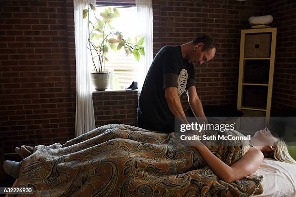 Massage therapist Joby Siciliano treats Brittany Shaney at Chanda Plan in Lakewood, Colorado on January 20, 2017. Chanda Plan is a Lakewood nonprofit...