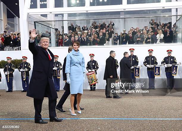 President Donald Trump waves as he walks with his wife first lady Melania Trump in front of the White House on January 20, 2017 in Washington, DC....