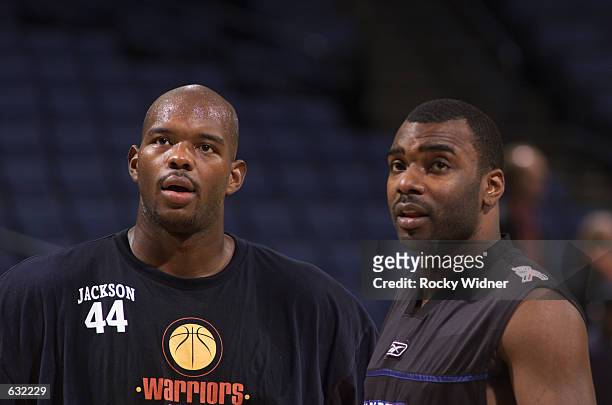 Marc Jackson of the Golden State Warriors talks with Aaron Mckie of the Philadelphia 76ers before their game at The Arena in Oakland, California....