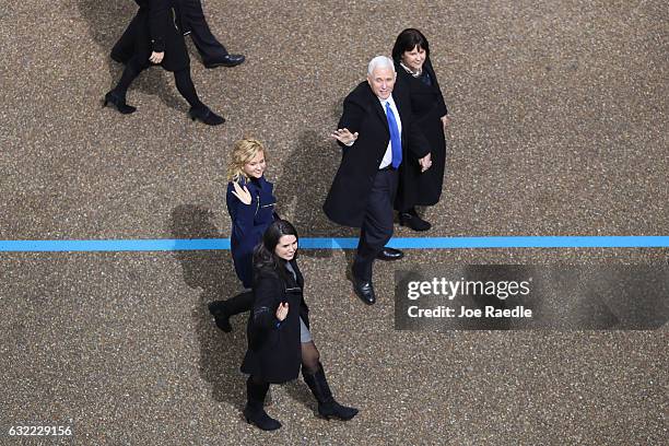 Vice President Mike Pence waves to supporters as he walks the parade route with his wife Karen Pence and their daughters Audrey Pence and Charlotte...