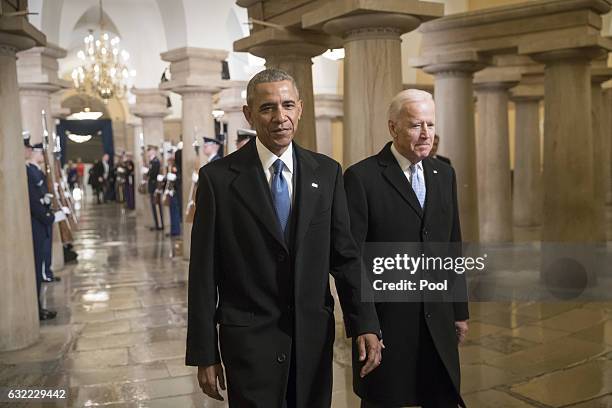 President Barack Obama and Vice President Joe Biden walk through the Crypt of the Capitol for Donald Trump's inauguration ceremony, in Washington,...