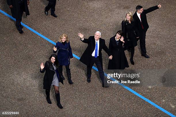 Vice President Mike Pence waves to supporters as he walks the parade route with his wife Karen Pence and their daughters Audrey Pence and Charlotte...