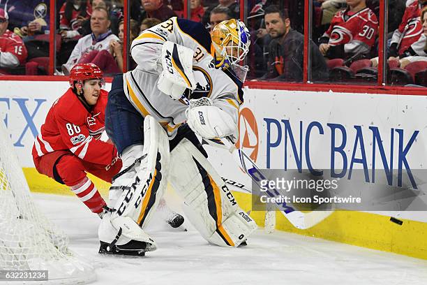 Carolina Hurricanes Center Teuvo Teravainen skates up to Buffalo Sabres Goalie Anders Nilsson as he clears the puck from the trapezoid in a regular...