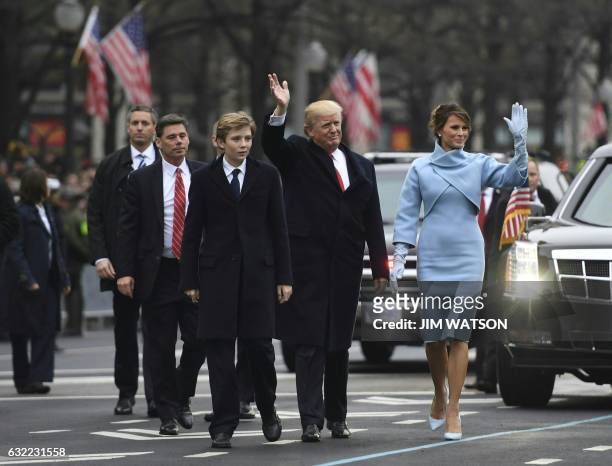 President Donald Trump and First Lady Melania walk the inaugural parade route with son Barron on Pennsylvania Avenue in Washington, DC, on January...