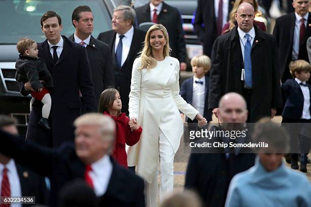 Jared Kushner, holding son Theodore Kushner, walks with wife Ivanka Trump and daughter Arabella Kushner behind U.S. President Donald J. Trump and...
