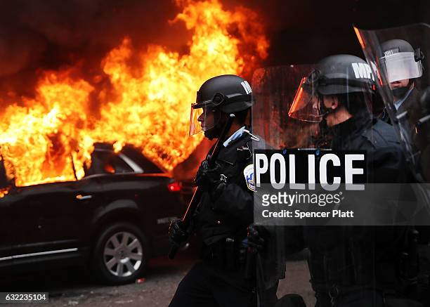 Police and demonstrators clash in downtown Washington after a limo was set on fire following the inauguration of President Donald Trump on January...