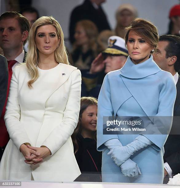 First lady Melania Trump , stands with Ivanka Trump as a parade passes the inaugural parade reviewing stand in front of the White House on January...