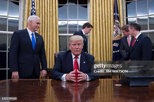 President Donald Trump waits at his desk before signing confirmations for James Mattis as US Secretary of Defense and John Kelly as US Secretary of...