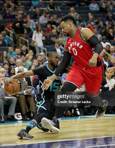 Jared Sullinger of the Toronto Raptors tries to stop Kemba Walker of the Charlotte Hornets during their game at Spectrum Center on January 20, 2017...