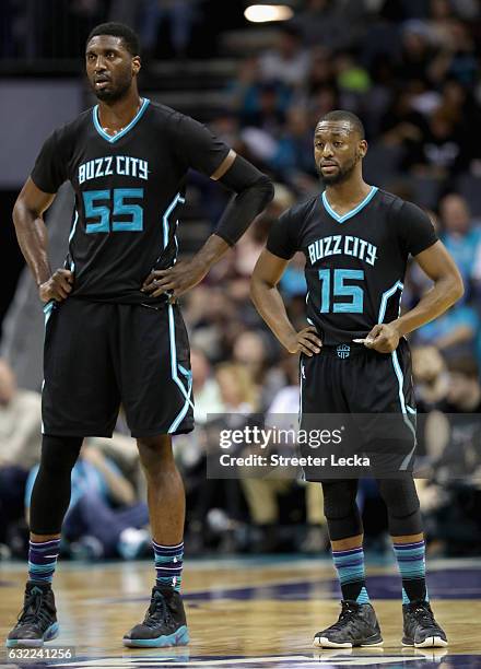 Teammates Roy Hibbert and Kemba Walker of the Charlotte Hornets watch on against the Toronto Raptors during their game at Spectrum Center on January...