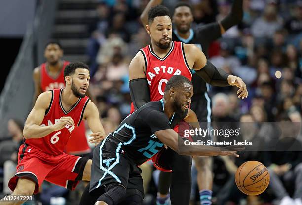 Teammates Cory Joseph and Jared Sullinger of the Toronto Raptors try to stop Kemba Walker of the Charlotte Hornets during their game at Spectrum...