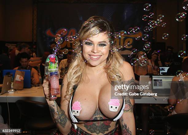 Webcam model Karen Materia shoots bubbles from a gun at the Chaturbate booth during the 2017 AVN Adult Entertainment Expo at the Hard Rock Hotel &...