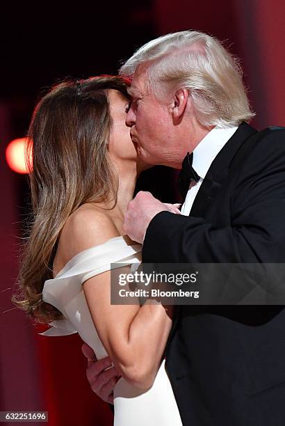 President Donald Trump kisses First Lady Melania Trump as they dance during the Liberty Ball at the Washington Convention Center in Washington, D.C.,...