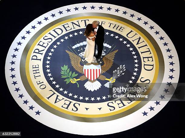 President Donald Trump and his wife First Lady Melania Trump kiss and dance on stage during A Salute To Our Armed Services Inaugural Ball at the...