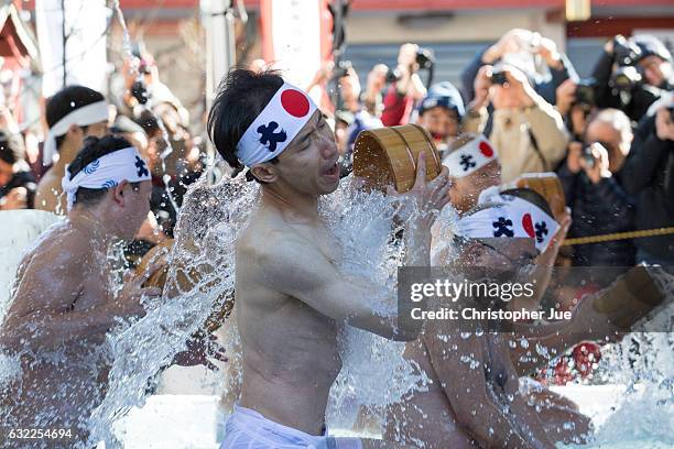 Participants splash ice-cold water on themselves during the ice water winter purification ceremony on January 21, 2017 in Tokyo, Japan. At Daikoku...