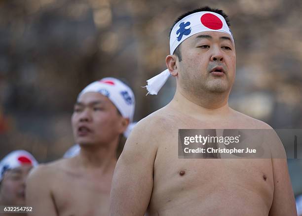 Participant meditates prior to the start of the ice water winter purification ceremony on January 21, 2017 in Tokyo, Japan. At Daikoku Matsuri...