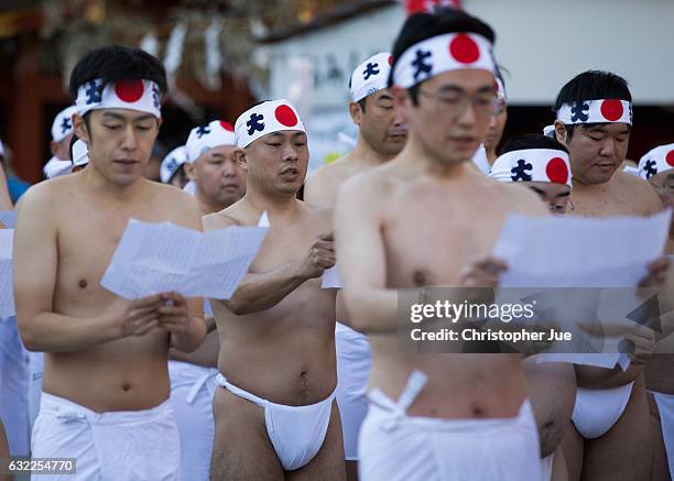 Participants recite prayers prior to the start of the ice water winter purification ceremony on January 21, 2017 in Tokyo, Japan. At Daikoku Matsuri...