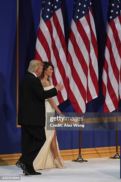 President Donald Trump and his wife First Lady Melania Trump walks on stage during A Salute To Our Armed Services Inaugural Ball at the National...