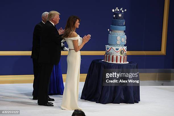 President Donald Trump, his wife First Lady Melania Trump, Vice President Mike Pence and Karen Pence clap before cutting the cake during A Salute To...
