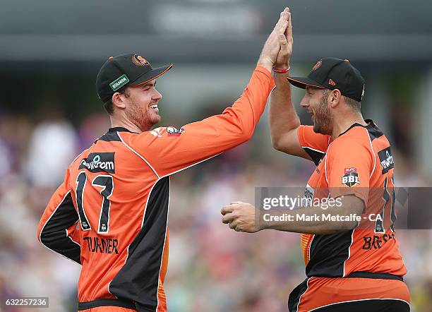 Ashton Turner of the Scorchers and Tim Bresnan of the Scorchers celebrate after taking a catch to dismiss George Bailey of the Hurricanes during the...