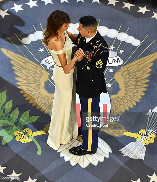 First Lady Melania Trump dances with a Marine at the A Salute to Our Armed Services Ball on January 20, 2017 in Washington, D.C. Trump will attend a...