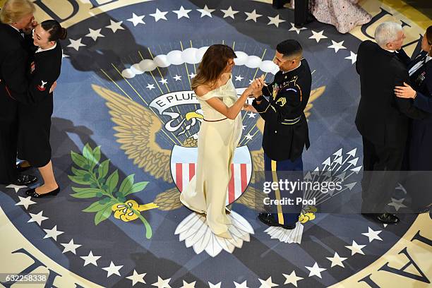 First Lady Melania Trump dances with a Marine at the A Salute to Our Armed Services Ball on January 20, 2017 in Washington, D.C. Trump will attend a...