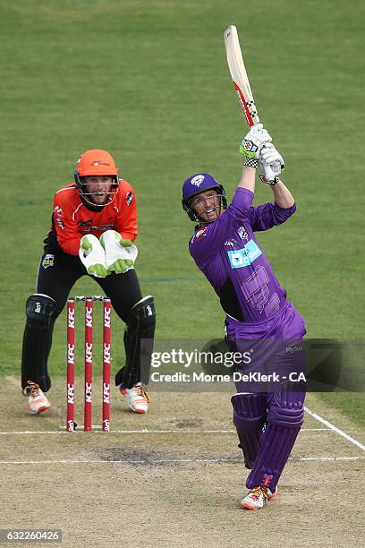 George Bailey of the Hobart Hurricanes plays a shot to get out in front on Sam Whiteman of the Perth Scorchers during the Big Bash League match...