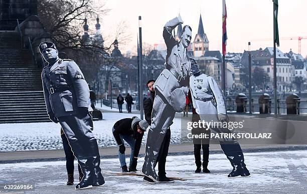 Activists of Avaaz civic organization set up three-meter-high images of former far-right leaders Mussolini, Hitler and Pétain in front of the towns...