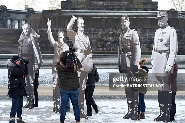 Journalists take pictures of three-meter-high images of former far-right leaders Franco, Stalin, Hitler Mussolini and Pétain set up by activists of...