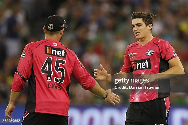 Michael Lumb and Sean Abbott of the Sydney Sixers celebrate a wicket during the Big Bash League match between the Melbourne Stars and the Sydney...