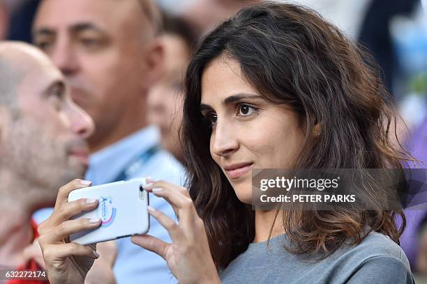 Xisca Perello, girlfriend of Spain's Rafael Nadal, uses a smartphone during his men's singles third round match against Germany's Alexander Zverev on...