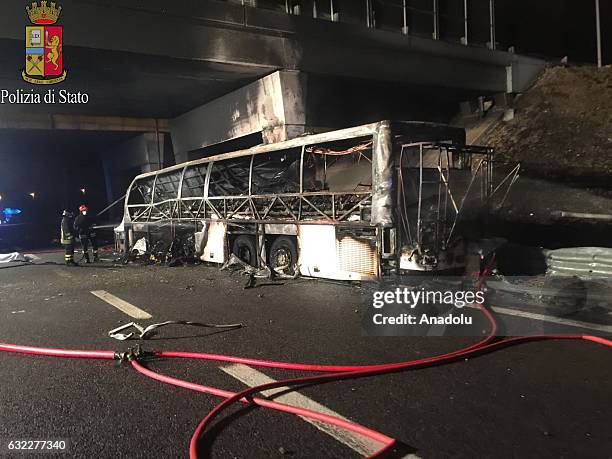 Burned bus, were carrying Hungarian students those were returning to Budapest from a school trip from France, is seen as fire fighters cool it down...