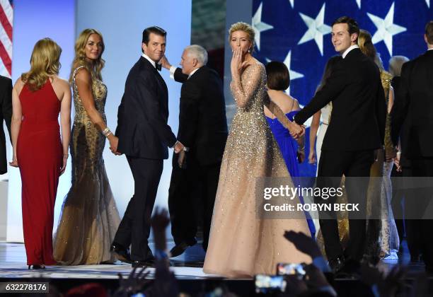 Ivanka Trump blows a kiss to the crowd as she leaves the stage with her husband Jared Kushner and her brother Donald Trump Jr and his wife Vanessa...