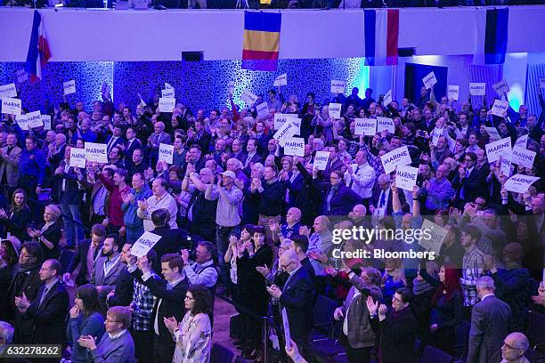 Attendees applaud and hold placards reading "Marine Le Pen" during a Europe of Nations and Freedom meeting in Koblenz, Germany, on Saturday, Jan. 21,...