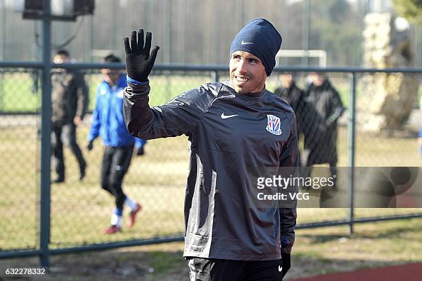 Argentine striker Carlos Tevez waves his hand during his first training session with his new club Shanghai Shenhua on January 21, 2017 in Shanghai,...