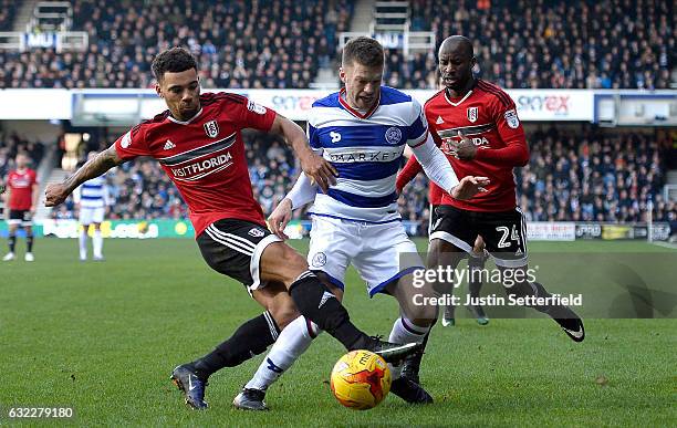 Jamie Mackie of Queens Park Rangers is fouled by Scott Malone of Fulham FC during the Sky Bet Championship match between Queens Park Rangers and...