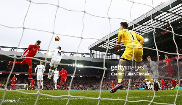 Roberto Firmino of Liverpool scores his sides first goal past Lukasz Fabianski of Swansea City during the Premier League match between Liverpool and...