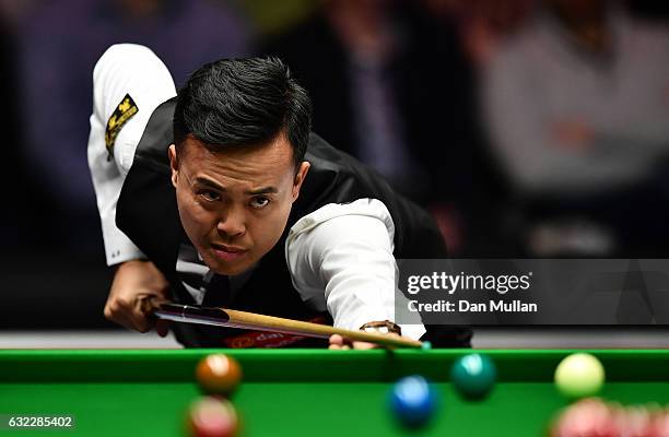 Marco Fu of Hong Kong plays a shot during his semi final match against Ronnie O'Sullivan of England on day seven of the Dafabet Masters at Alexandra...