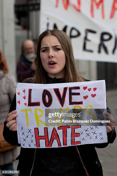 Women shouts slogans as she holds a placard reading 'Love. Trump. Hate.' during a demonstration in front of the US Embassy on January 21, 2017 in...