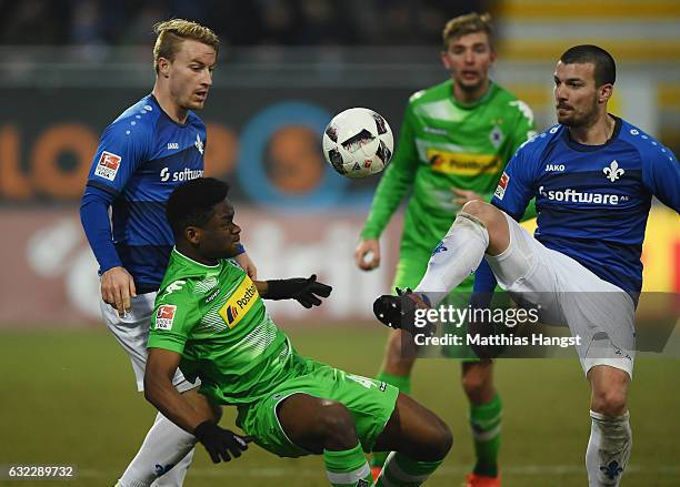 Ba-Muaka Simakala of Gladbach is challenged by Jerome Gondorf of Darmstadt during the Bundesliga match between SV Darmstadt 98 and Borussia...