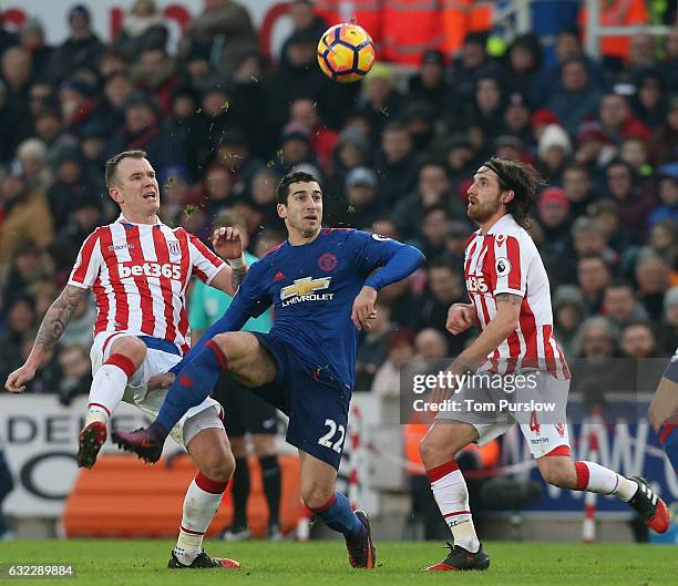 Henrikh Mkhitaryan of Manchester United in action with Glenn Whelan and Joe Allen of Stoke City during the Premier League match between Stoke City...