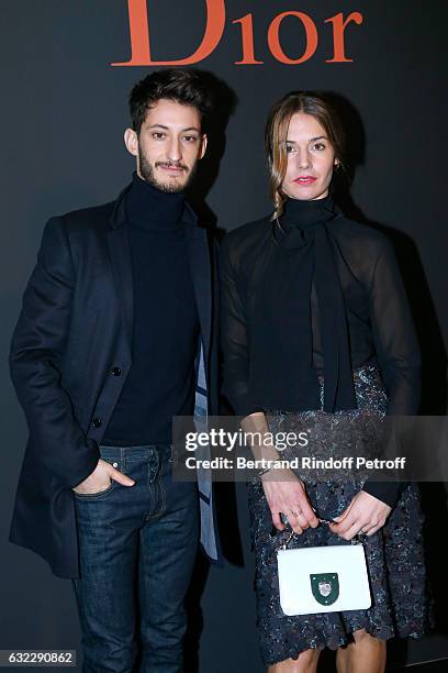 Pierre Niney and Natasha Andrews attend the Dior Homme Menswear Fall/Winter 2017-2018 show as part of Paris Fashion Week on January 21, 2017 in...